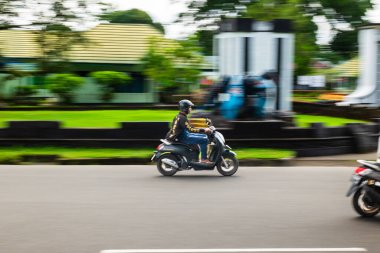 Ambon, Endonezya - 20 Haziran 2024: Otoyolda motosiklet sürmek