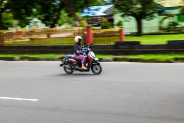 Ambon, Endonezya - 20 Haziran 2024: Otoyolda motosiklet sürmek