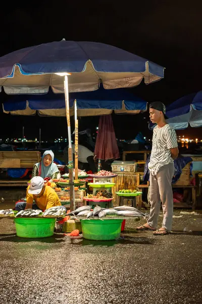 stock image Ambon, Indonesia - June 30, 2024: Selling fish on the roadside at a traditional market at night