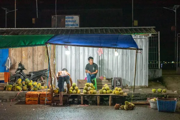 stock image Ambon, Indonesia - June 30, 2024: Selling vegetables and fruit on the roadside at a traditional market at night