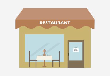 Sandalyesi ve açık masası olan bir restoran..