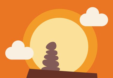 Gün batımında ya da gündoğumunda bir zirvede yığılmış taşlar.