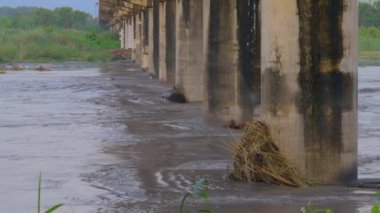 In the swollen stream, what flows is not water, but mud. Because every time a heavy rain passes, the hillside collapses, and the soil is washed into the stream. Kaohsiung, Taiwan. 4K High angle view. Medium telephoto lens.