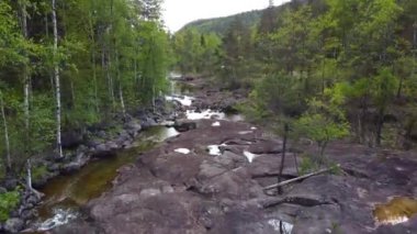 Ağaçları ve pürüzsüz kayaları olan Sakin Güzel Nehir - Grovane, Norveç 2.7K Hava Görüntüsü