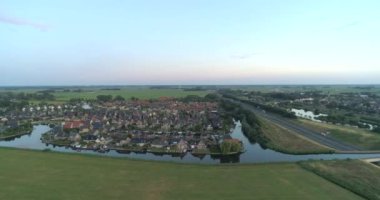 Su kemerine yakın küçük bir kasaba, rıhtım evleri - Akkrum, Friesland, Hollanda, 4K Drone Görüntüleri