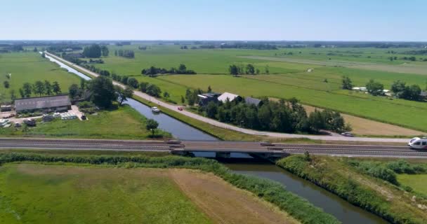 Red White Train Crossing Small Bridge Canal Stationary Shot Friesland — Stok Video
