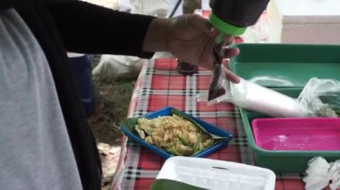Soya fasulyesinden yapılmış Endonezya spesiyali Tempe Mendoan 'ı kızartan sokak yemekleri satıcısı..