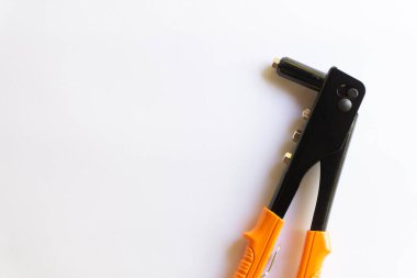 Turuncu saplı perçin aleti ve beyaz arka planda izole edilmiş çeşitli el perçinleri için gümüş kör perçin..