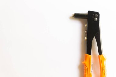 Turuncu saplı perçin aleti ve beyaz arka planda izole edilmiş çeşitli el perçinleri için gümüş kör perçin..