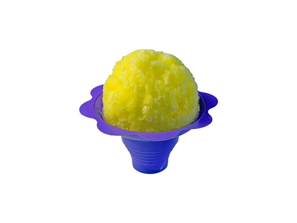 Lemon yellow Hawaiian Shave ice, shaved ice or snow cone dessert in a purple flower shaped cone on a white background with copy space.