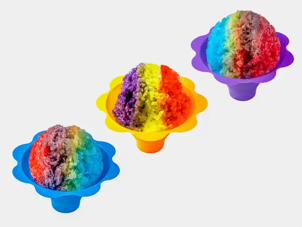 stock image Three rainbow Hawaiian shave ice, shaved ice or snow cone desserts in a row against a white background