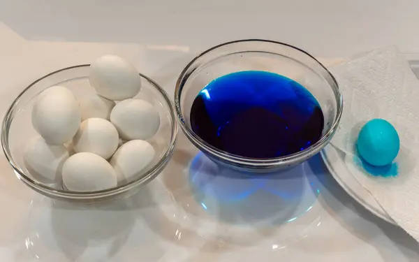 Coloring hard boiled eggs with blue dye for Easter Eggs
