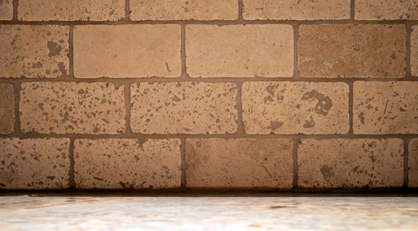 Travertine tile wall over a granite base background.