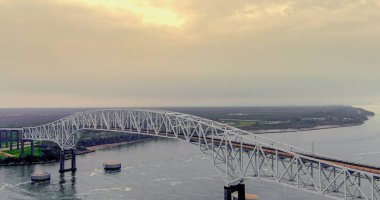 Aerial view of the Sabine Lake Causeway Bridge at Port Arthur Texas on an overcast day. clipart
