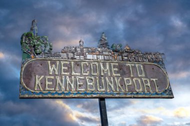 Kennebunkport Maine, USA - October 23, 2021: Metal Welcome to Kennebunkport sign against an overcast sky at sunset. Kennebunkport is a popular tourist destination in Maine along the coast of the Atlantic Ocean. clipart