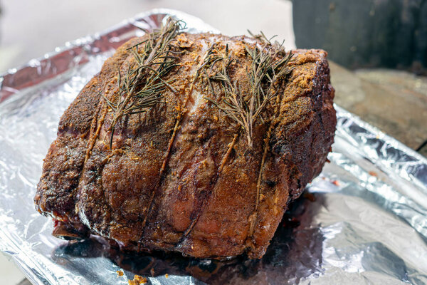 Roasted seasoned beef prime rib cooked on the bone and ready to carve into steaks for a great holiday entree