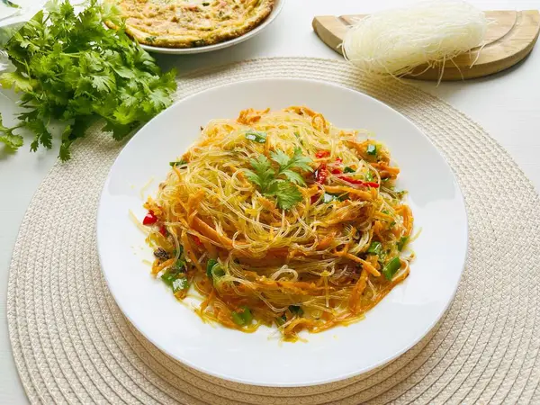 stock image Bihun goreng, bee hoon goreng or mee hoon goreng refers to a dish of fried noodles cooked with rice vermicelli in both the Indonesian and Malay. Cooked with vegetables