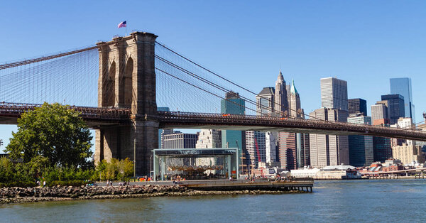 Brooklyn bridge with the Manhattan skyline in the distance