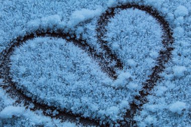 winter hearts in the cold in frost, winter hearts in the cold in frost, a declaration of love in the snow, a cold heart in winter.