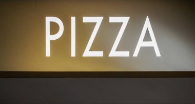 The word Pizza is highlighted in white on a gold background. High quality photo