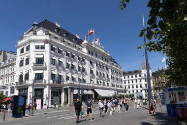 Kopenhag 'ın en lüks D' Angleterre Oteli. Güneşli bir yaz gününde Danimarka bayraklarıyla. Kopenhag, Denmaerk - 26 Temmuz 2023