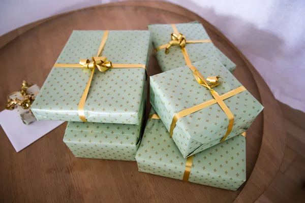 Gifts wrapped in green gift paper with yellow ribbon. High quality photo