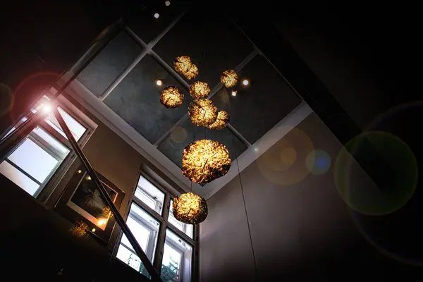 Beautiful golden chandeliers in a dark room. Room lighting. High quality photo