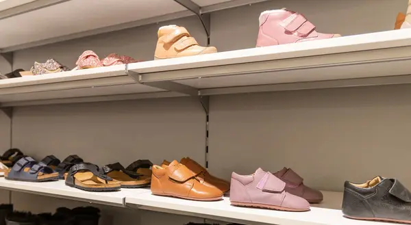 Children's shoe store. Shelf in the store with baby winter boots. High quality photo