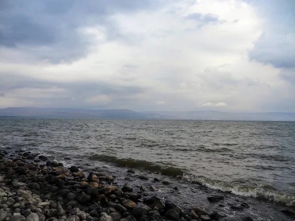 Rocky shore of the sea or lake.The sea of Galilee also called Lake Tiberias or Kinneret, Israel. High quality photo
