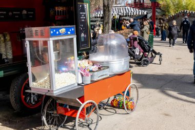 Retro Popcorn popper Machine in the park. Copenhagen, Denmark - April 9, 2024. clipart