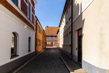 Narrow streets of the old town with colorful houses Ystad, Sweden. clipart