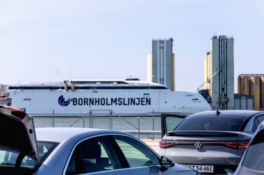 Seaport and Bornholmsslinjen terminal for passenger ferry transport in the city of Ystad. Line of cars waiting to board the ferry. Ystad, Sweden - May 15, 2024. High quality photo clipart