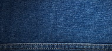 texture of blue jeans denim fabric with seam background