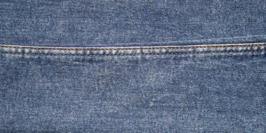 texture of blue jeans denim fabric with seam background