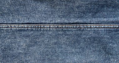 texture of blue jeans denim fabric with seam background