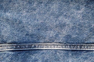 texture of blue jeans denim fabric with seam background