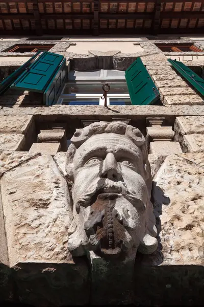 Stone sculpture of Man head on the facade of an old building in Udine Friuli Venezia Giulia Italy