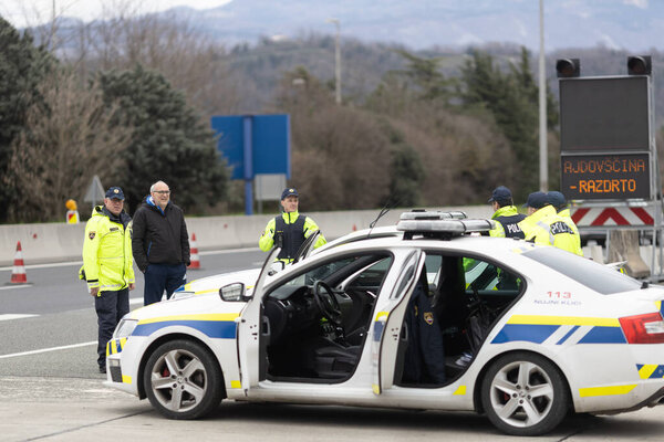 Vrtojba, Slovenia - March 14, 2019: Schengen border between Slovenia and Italy on the Highway closed with exceptions due to Pandemic COVID-19 with Slovene Police Forces Control All Vehicles Passing trough for signs of contagion.