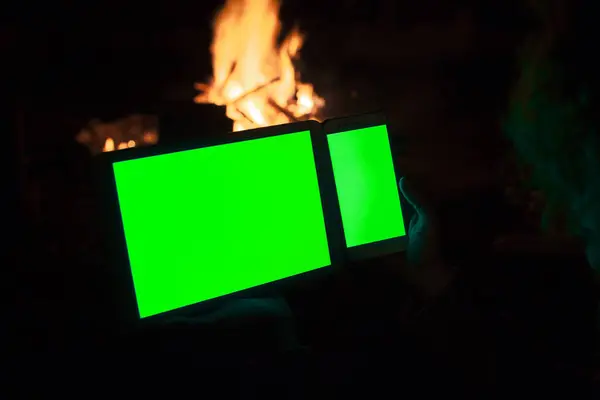 Smart Phone And Tablet With Green Screen on Fire Background by Night
