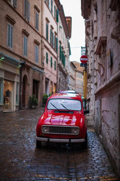 An old european oldtimer car on streets of medieval Italian town