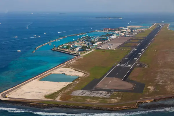 An air-view of the Maldivian international airport from a seaplane landing at the seaplane airport near it.