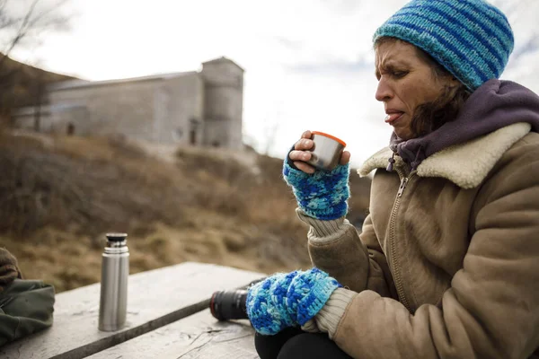 Bad taste of Hot Drink From a Thermos for a Female Hiker Outdoors