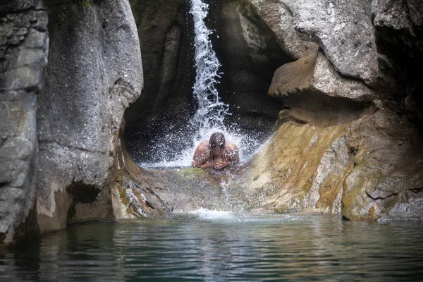 Meditation Under a Powerful Waterfall in Nature Wilderness For an Adult Man
