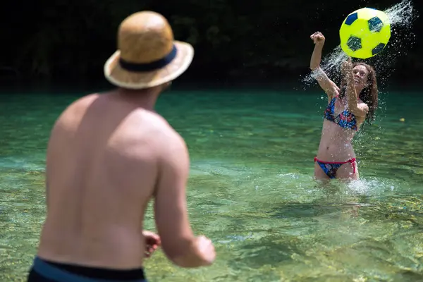 Tornado Spray Move Against Male Friend in Active Summer Vacation Ball Game for Adult Serene Woman in Bikini Refreshing in Low River Water