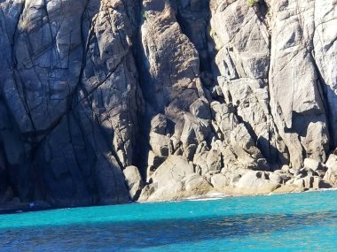  Arraial do Cabo, Brezilya: Açık zümrüt denizi ve güneşli bir gökyüzünün altındaki kayalık tepeler.