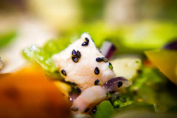 stock image Piece of chicken with vegetables and sesame. Macro photo