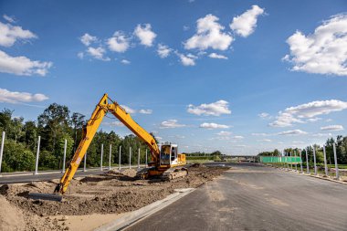 Road building. Highway construction and machines used for construction. Excavator, bulldozer, roller