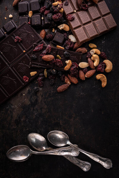Chocolate. Delicious chocolate set against a background of cocoa, nuts and coffee