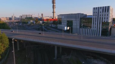 Helsinki.Finland-August 30.2021: Beautiful aerial shot of the Tv tower in Helsinki Finland showing the idyllic cityscape. Cars driving by. Nordic architecture. Camera slowly tilting upwards.