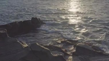 The sunset on the sky with the seawaves in Teno Canary Islands in Tenerife Spain with the rocks on it.geology shot.4k